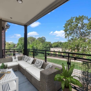 Beautiful balcony views with patio lounge furniture and lush green trees