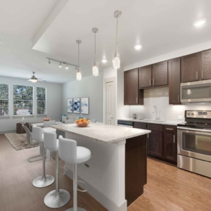 Wide angle view of 1 bedroom home's modern kitchen with stainless appliances