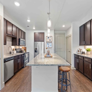 Galley kitchen with stainless appliances and custom builtins