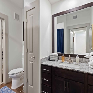 large framed mirror in bathroom with granite